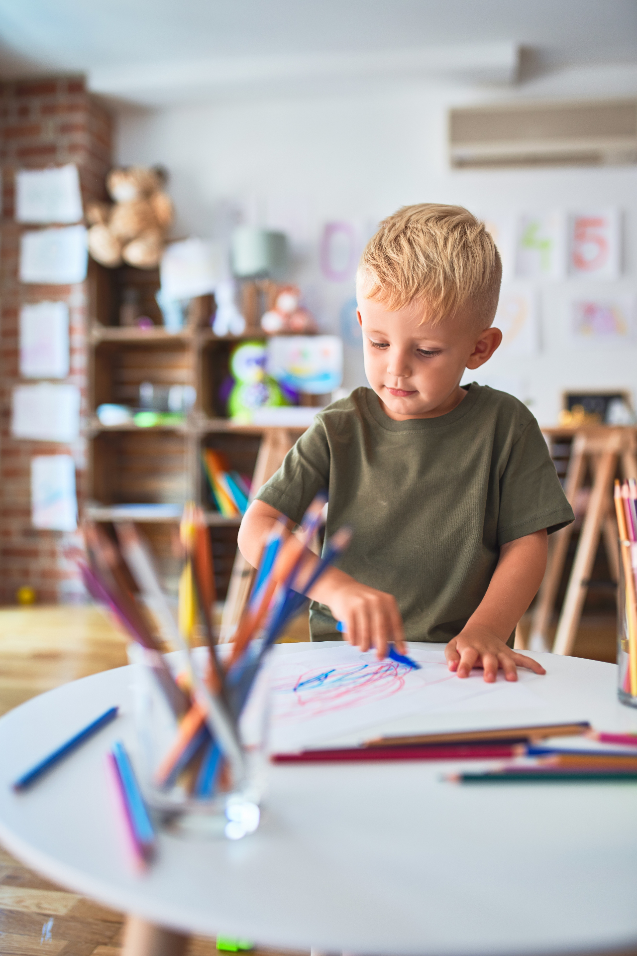 Young child coloring at a table